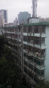 Apartment building with laundry and air conditioners and detritus.